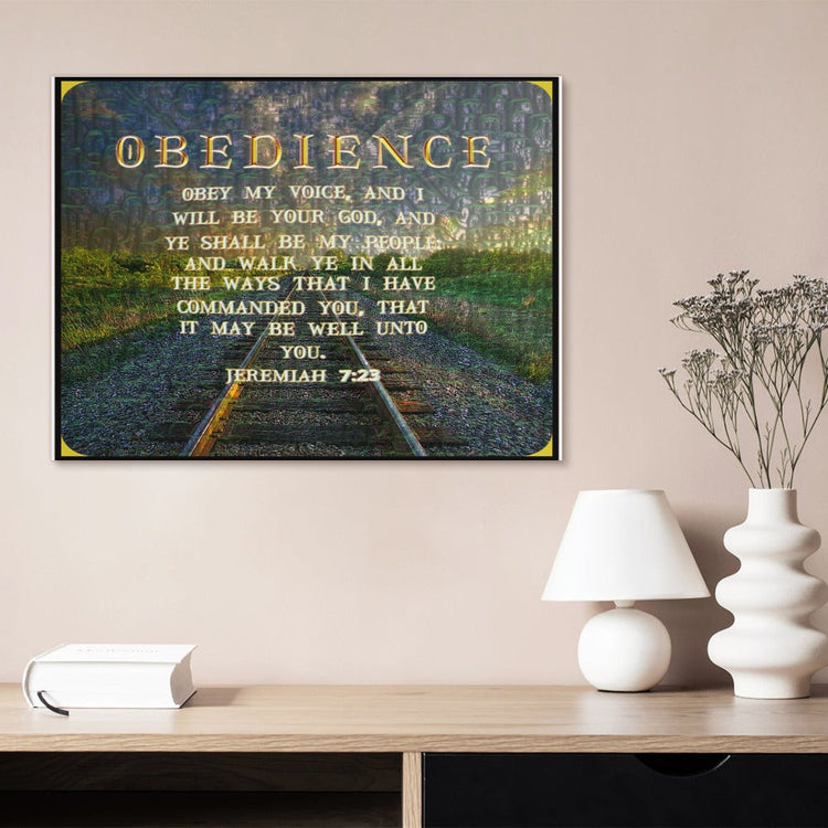 Framed wall art featuring "OBEDIENCE" and Jeremiah 7:23 over a railroad track landscape, displayed on a wall above a wooden desk with a lamp.
