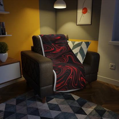 A red and black marbled blanket draped over a brown leather armchair in a modern living room with warm lighting.