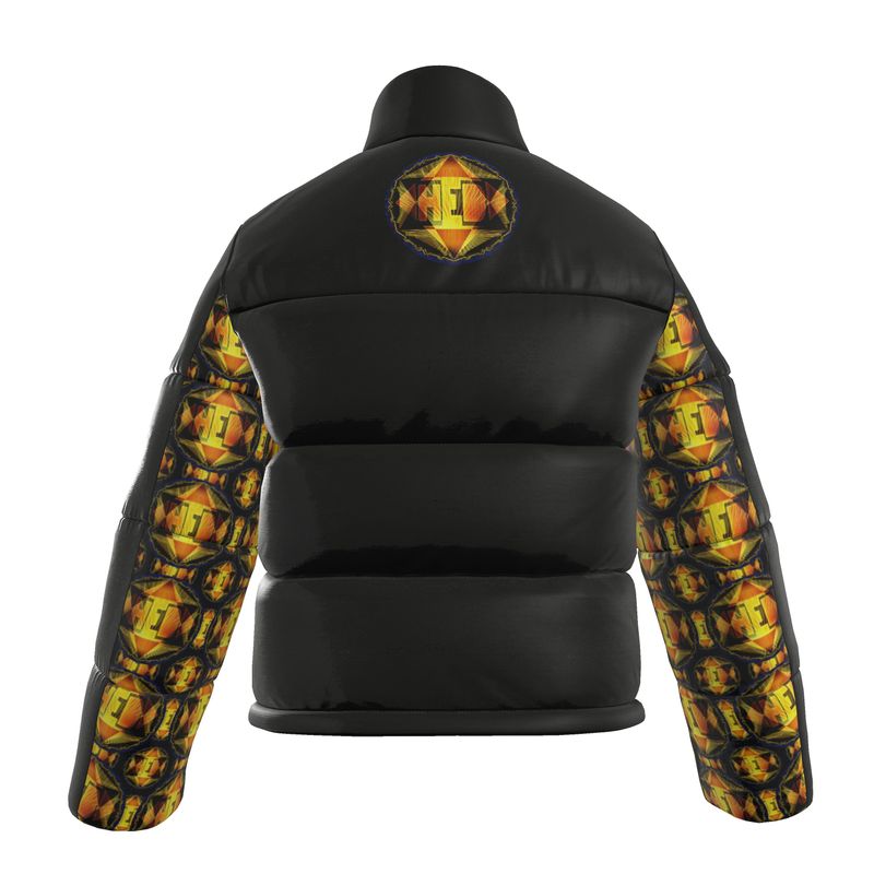 The back of the Royal Radiance black puffer jacket, showing a large, centered 'HEB' emblem between the shoulders. The full length of both sleeves is covered in a vibrant, repeating Hebrew-inspired geometric pattern in shades of orange, yellow, and gold.
