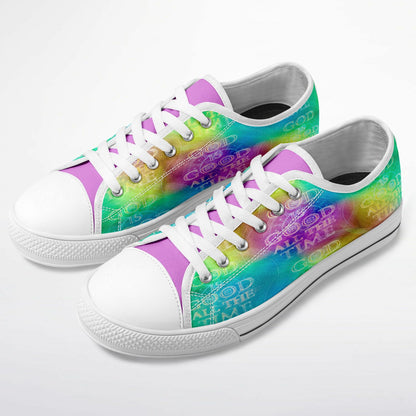 A pair of colorful low-top sneakers with a vibrant tie-dye pattern and the repeating white text "GOD IS GOOD ALL THE TIME" across the sides.