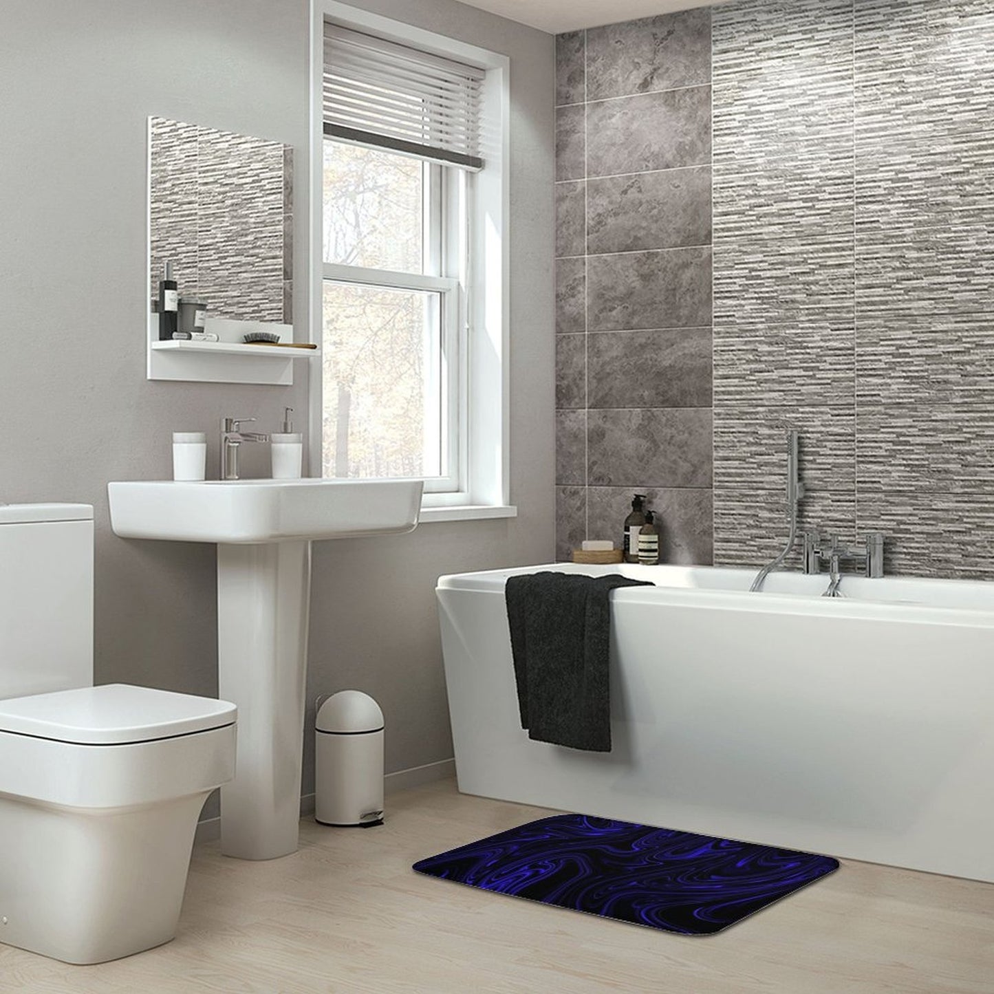 Flow (01-02): Cobalt, The Heavenly Depths bath rug placed in a modern grey-tiled bathroom setting. Archival design adds a kinetic pop to a minimalist interior.