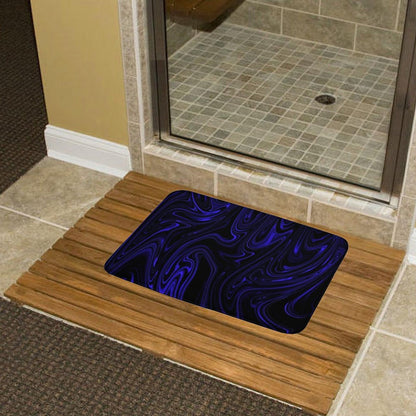Flow (01-02): Cobalt bath rug on a wooden slat mat by a glass shower door. Highlights the contrast between the organic fluid design and natural textures.