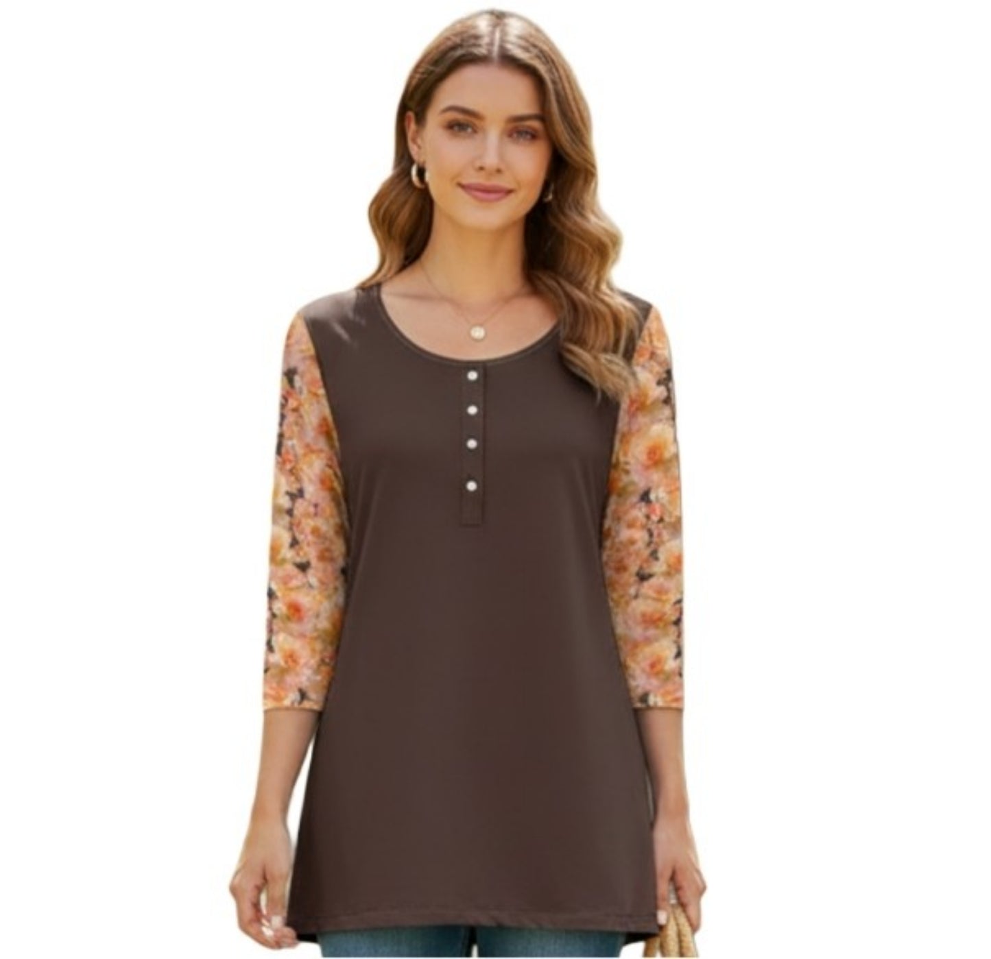 A front view of a woman smiling, wearing a mixed-media tunic top. The body of the shirt is a solid chocolate brown with a round neckline and a vertical row of four white buttons. The three-quarter length sleeves feature the same peach-colored rose floral print seen on the back of the garment.