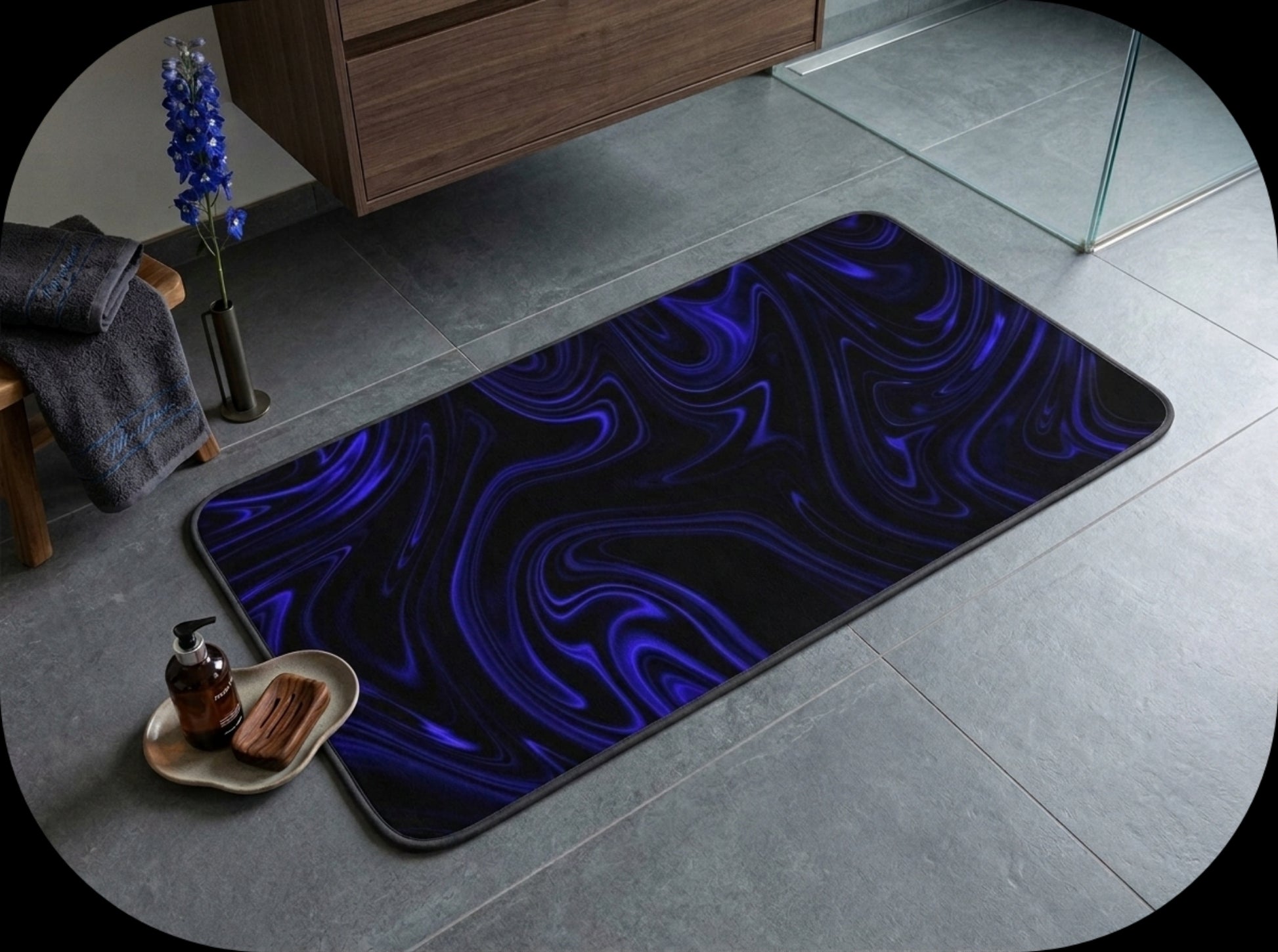 Wide perspective shot of a modern bathroom with the Cobalt Heavenly Depths bath mat placed near a walk-in shower and floating vanity.