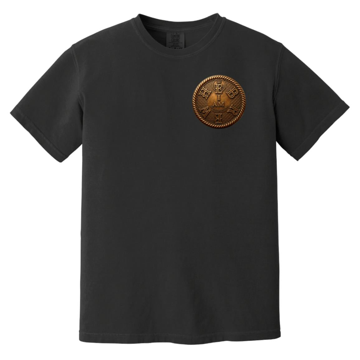 Flat lay of a black adult heavyweight tee showing the front with a circular gold "I AM" chest badge.