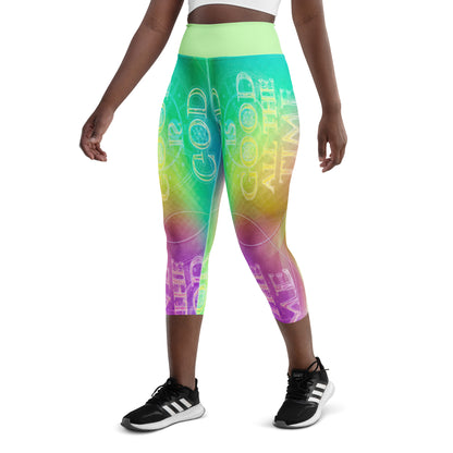 Back view of a person wearing rainbow gradient capri leggings with a neon "GOD IS GOOD" typography print and a light green waistband.