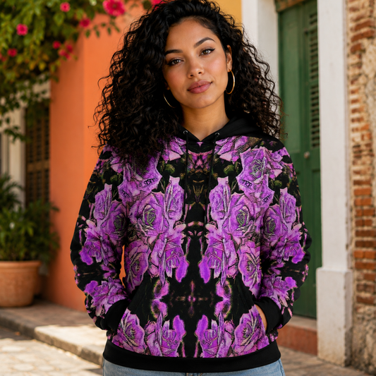 A woman with curly hair wearing the Argamon Noble Reflection fleece hoodie featuring a vibrant purple embossed floral pattern against a street background.
