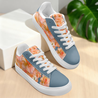 Pair of women'slow-top sneakers featuring a peach and apricot floral pattern with slate blue panels and white rubber soles. 
