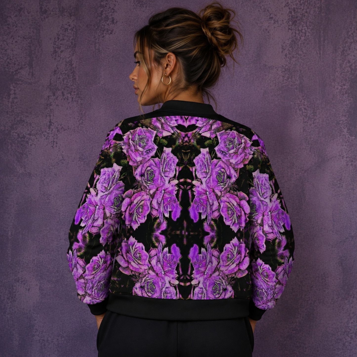 Back view of a woman showcasing the symmetrical purple rose pattern on the Argamon noble reflection bomber jacket.