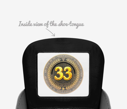 Inside view of the shoe tongue featuring a circular gold emblem with the number 33 and the text "Resurrection and Ancient Authority."