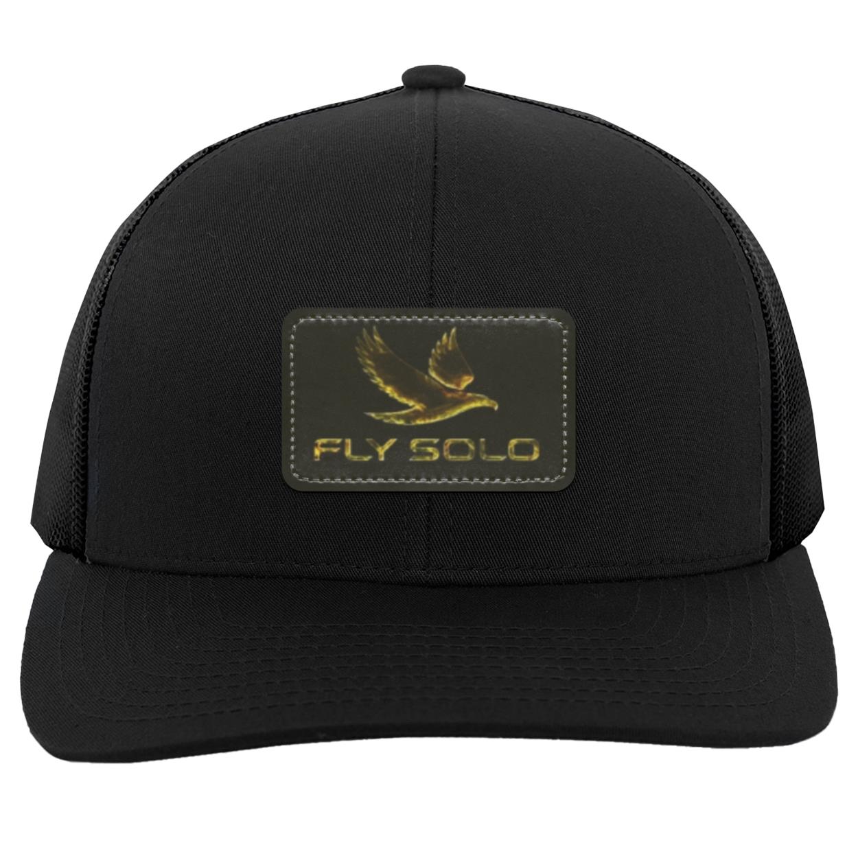 Clean front product shot of the solid black Fly Solo trucker hat with gold embossed branding.