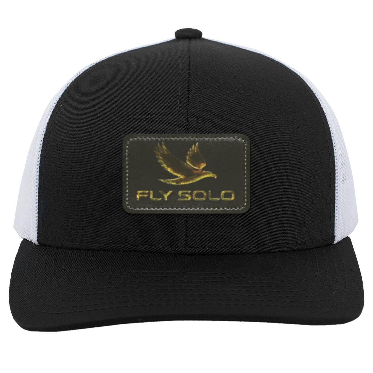 Front product shot of the black and white Fly Solo trucker snapback featuring the signature gold eagle leather patch.