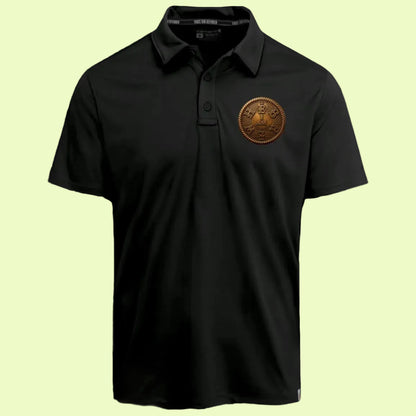 Studio shot of the front of the black adult "I AM HEBREW" Force Sun Defender polo shirt laid flat against a beige background, featuring the bronze circular logo.