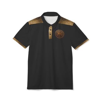 A flat-lay photo of a black polo shirt with gold-patterned shoulder panels, a bronze medallion logo on the left chest, a gold placket, and matching gold cuffs. It has a white inner neck lining and is on a white background.
