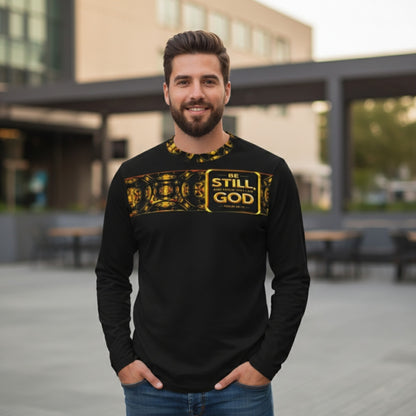 Front view of a man in a black long-sleeve shirt featuring a gold ornate pattern band across the shoulders, standing in an outdoor urban setting.