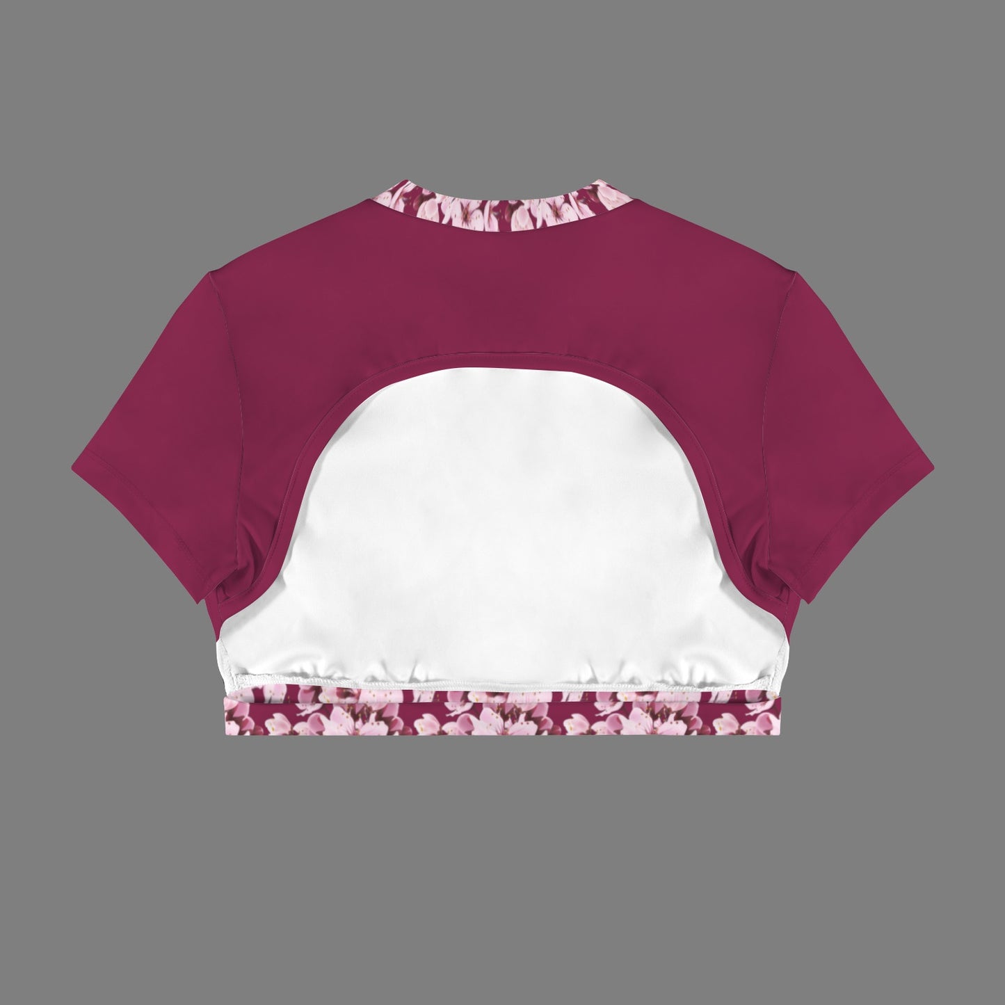 Product flat lay back view of the Sakura Symphony magenta crop top, displaying the dramatic crescent cutout and white inner lining.