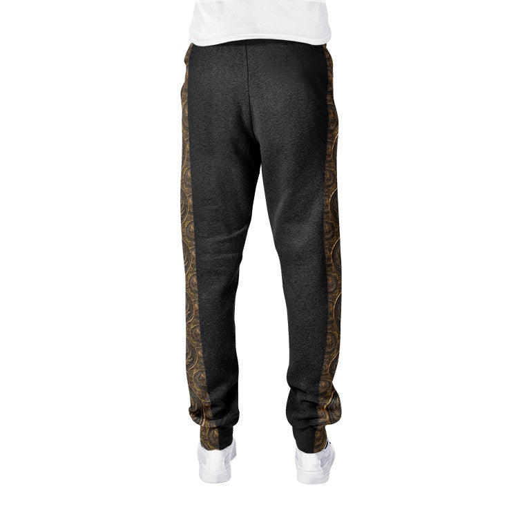Isolated back view of dark charcoal cotton-blend joggers highlighting the seamless edge of the bronze patterned side panels and ribbed ankle cuffs.