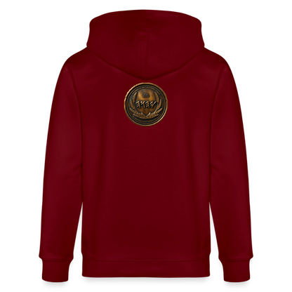 Back view of a burgundy organic zip hoodie featuring a large circular antiqued bronze medallion emblem centered on the upper back.