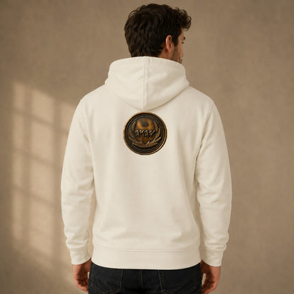 Back view of a white organic zip hoodie showing a detailed circular antiqued bronze medallion emblem centered on the upper back.