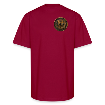 Front view of a burgundy oversized heavyweight t-shirt featuring a circular antiqued bronze Paleo-Hebrew medallion emblem printed on the left chest.