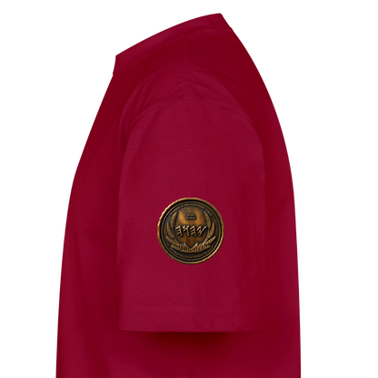 Side view showing the right sleeve of a burgundy oversized t-shirt detailed with a circular antiqued bronze Paleo-Hebrew medallion emblem.