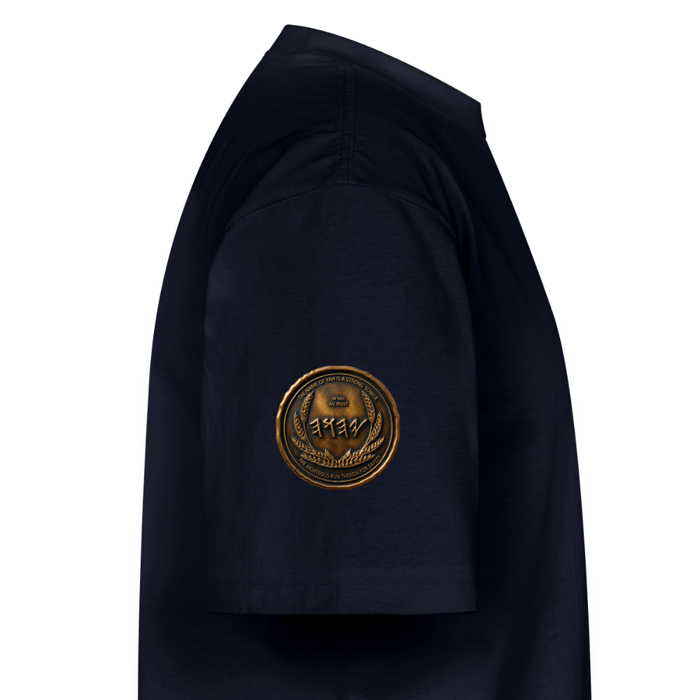 Side view showing the right sleeve of a navy blue oversized heavyweight t-shirt with a circular antiqued bronze Paleo-Hebrew medallion emblem.