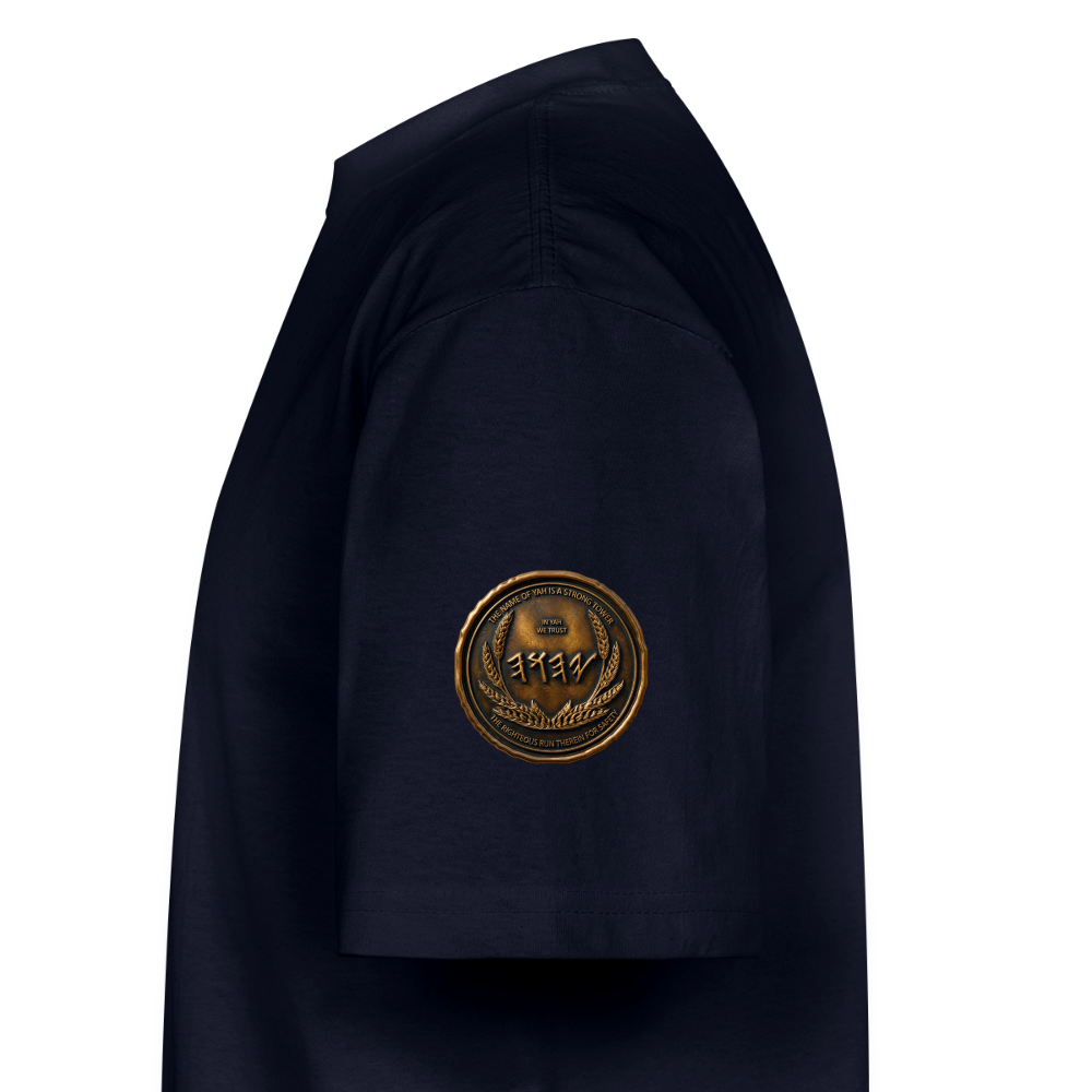 Side view showing the left sleeve of a navy blue oversized heavyweight t-shirt with a circular antiqued bronze Paleo-Hebrew medallion emblem.