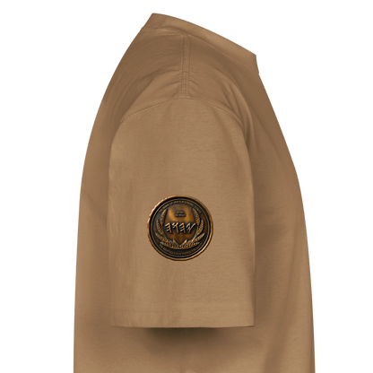 Side profile showing the left sleeve of a tan oversized heavyweight t-shirt with a circular antiqued bronze medallion emblem printed near the hem.