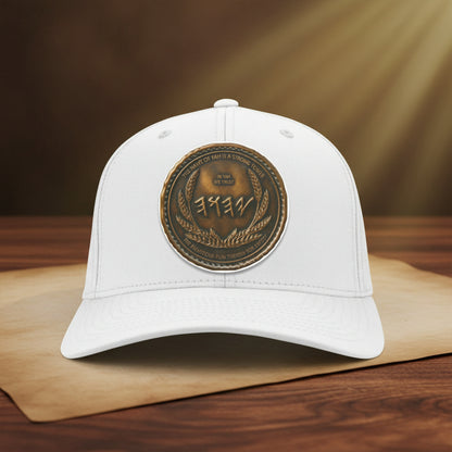 Front view of a crisp white structured baseball cap highlighted by a striking, metallic antiqued bronze central medallion print.