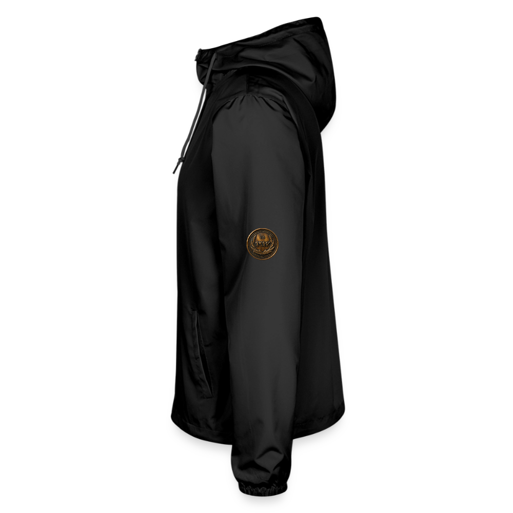 Left side profile view of a black lightweight windbreaker with a circular antiqued bronze Paleo-Hebrew script medallion on the upper sleeve.