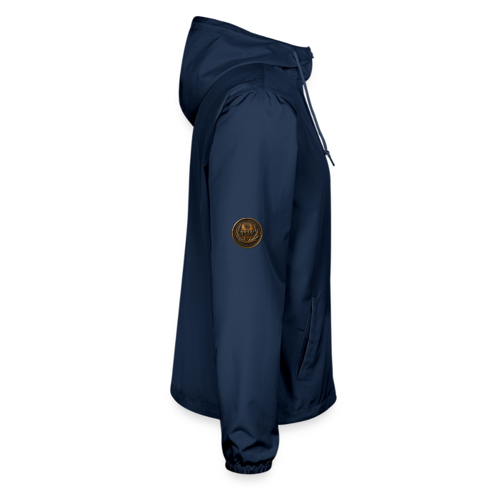 Right side profile view of a navy blue lightweight windbreaker showcasing an antiqued bronze Paleo-Hebrew medallion emblem on the upper sleeve.