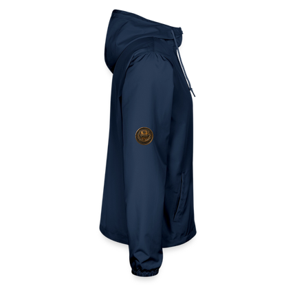 Right side profile view of a navy blue lightweight windbreaker showcasing an antiqued bronze Paleo-Hebrew medallion emblem on the upper sleeve.
