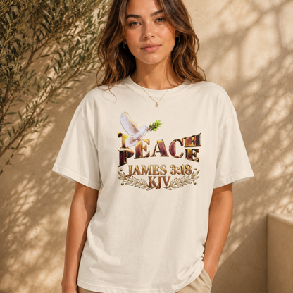 woman showcasing the sand Teach Peace James 3:18 oversized graphic tee in natural sunlight.
