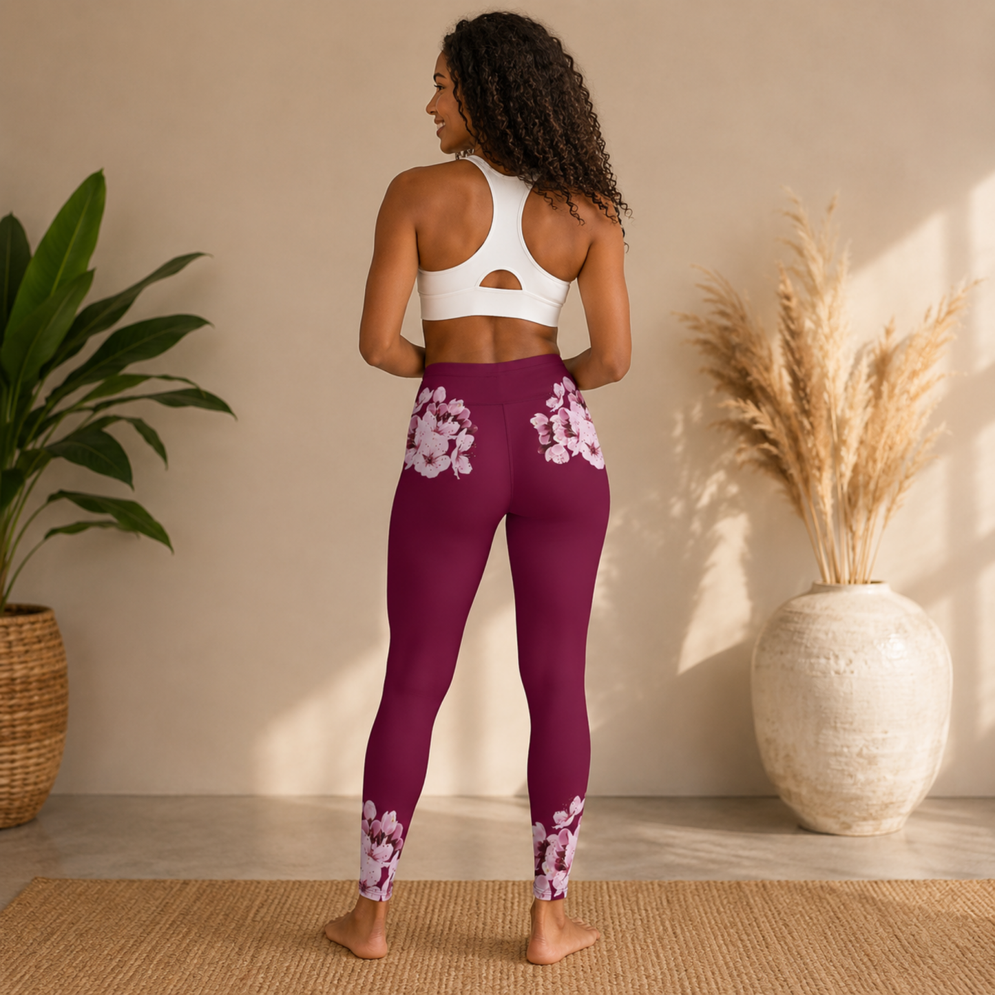 Rear view of a woman showcasing the back floral placement on the TRP Sakura Symphony high-waisted leggings.