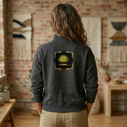 Back view of a woman in a charcoal heavyweight half-zip sweatshirt featuring the gold Yahuah Tree of Life emblem on the chest and a large back graphic.