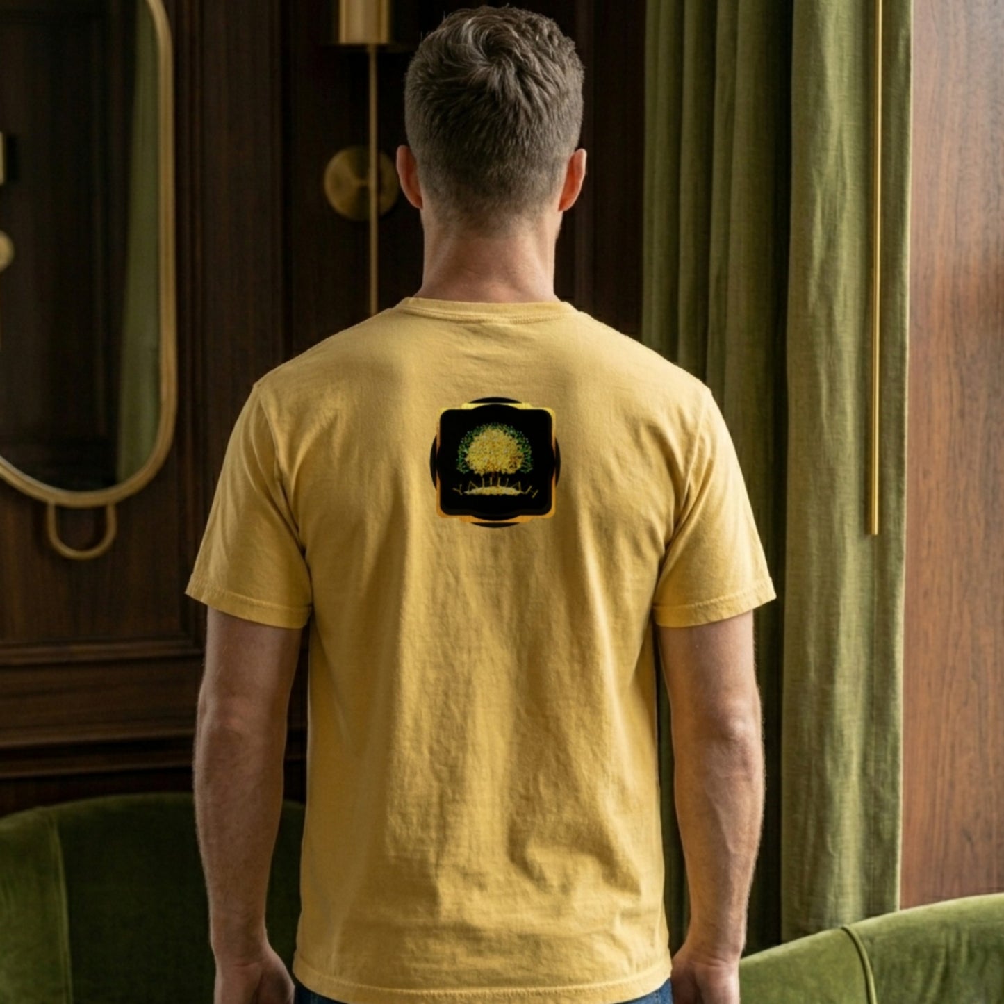 Back view of a man wearing a golden rod Yahuah: Tree of Life t-shirt with a small gold emblem on the upper back.