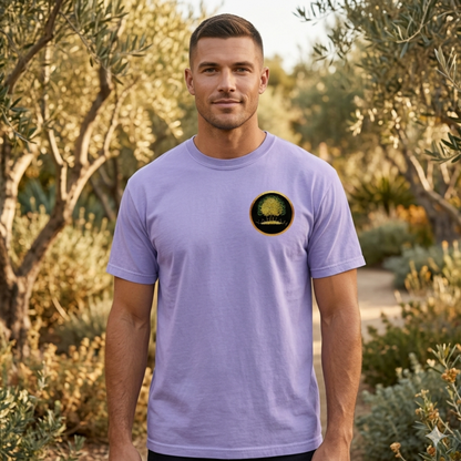 Front view of a man in an olive grove wearing a violet Yahuah: Tree of Life t-shirt with a golden tree emblem on the chest and upper back.