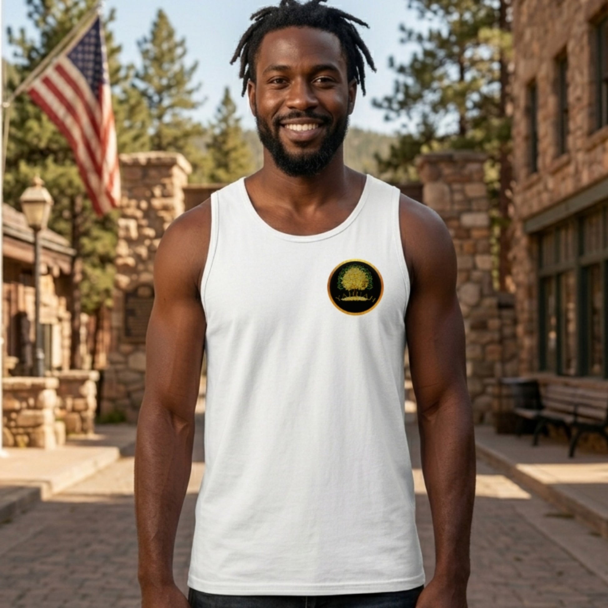 Front view of a man wearing a white longline tank top with a small circular Yahuah Tree of Life (03) logo on the left chest, featuring gold and green tones.
